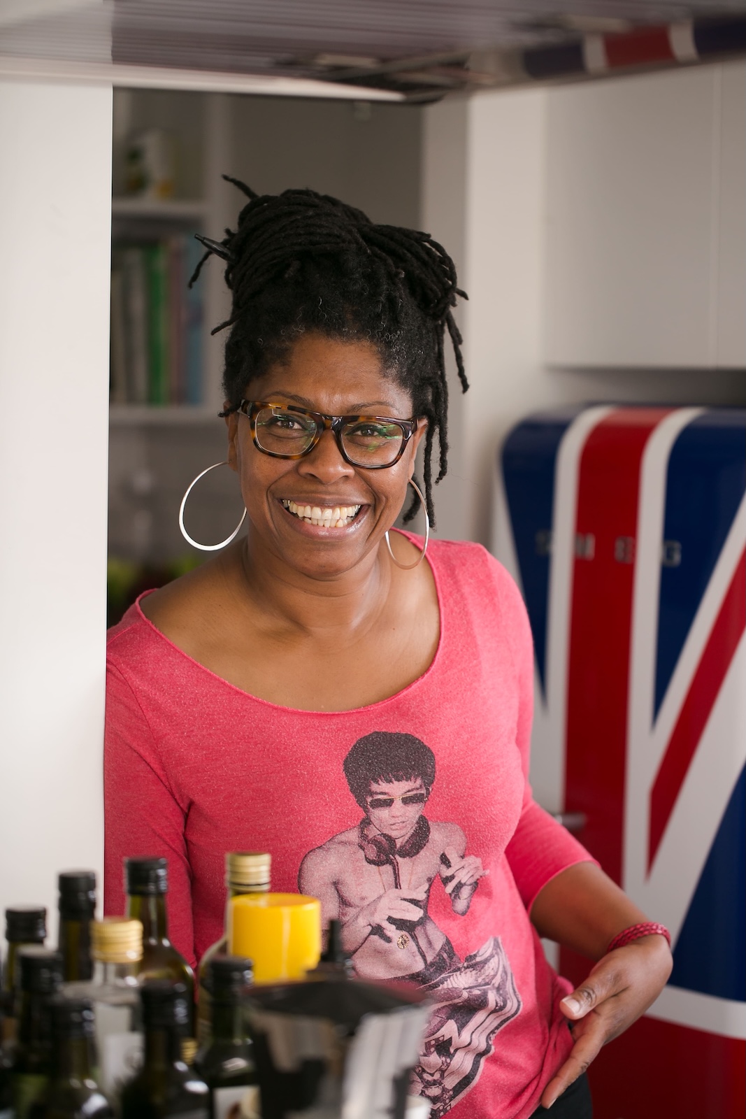 Jax Hamilton smiling broadly, relaxed and at home in front of a Union Jack fridge